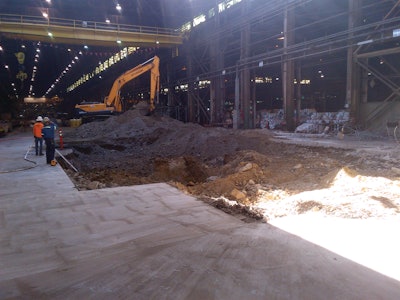The excavation in the Cal Steel building began by cutting a 40-foot square hole through an 8-inch pad.