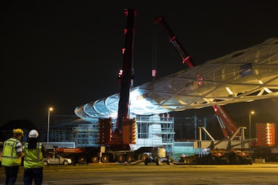 Three Terex cranes worked in tandem to lift two sections of a pedestrian bridge into place over the A15 motorway.