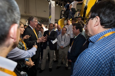 Doug Oberhelman, Caterpillar chairman and CEO, talks with visitors to Cat's CONEXPO 2014 exhibit.