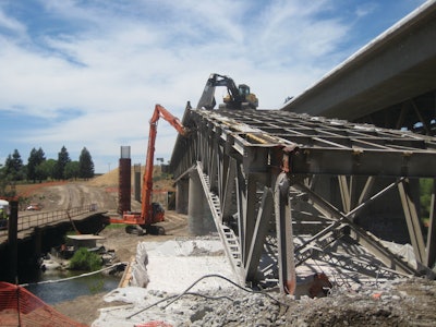 To prevent any debris from falling into the river, a protective cover was engineered to span the river and provide protection for the entire footprint of the bridge, plus 10 feet on either side of the structure.