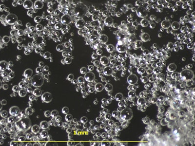 Microspheres are dispersed in a liquid admixture solution for ease of dispensing and mixing in concrete.