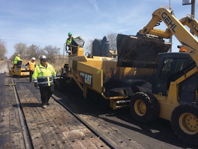 The material utilized in between the rails varies depending on local traffic volumes. In heavier industrial areas, the railroad will often spec a sturdier material such as wood.