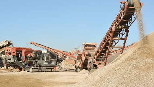 The Sandvik QI240 is a 43-ton crusher that moves on 20-inch-wide tracks and can be transported by trailer.