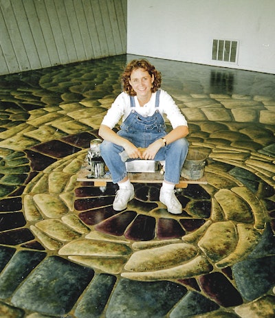 Laurie Carey, the artist who installed the decorative floor, built a platform on wheels to scoot herself and her paints around the floor.