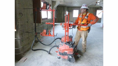 The universal drill jig was built to accommodate two drills in the saddle, allowing users to drill two holes at a time if desired. An optional dust collection system to protect workers against airborne crystalline silica is also available.