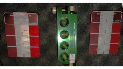 This laser alignment tool utilizes an industrial ruby laser and a pair of indexing scales to simplify the adjustment process.