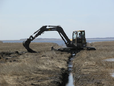 A Volvo ECR88 D-Series excavator fitted with unique swamp pads is working in the Connecticut coastal wetlands for the Wetlands Habitat and Mosquito Management (WHAMM) Program.