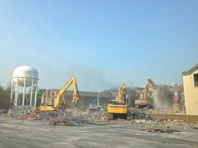 Demolition contractor Yannuzzi Group mobilized an arsenal of hydraulic excavators, loaders, end dumps and concrete crushers to help with the demolition and asbestos remediation of this one-million-square-foot former naval storage facility.