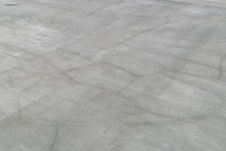 Random cracks in reinforced slabs caused by thermal contraction and drying shrinkage are not longitudinal cracks and typically do not increase the risk of reinforcement corrosion in concrete.