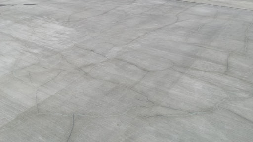 Random cracks in reinforced slabs caused by thermal contraction and drying shrinkage are not longitudinal cracks and typically do not increase the risk of reinforcement corrosion in concrete.