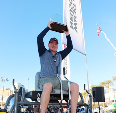 Wacker Neuson’s 2015 Trowel Challenge grand prize winner, Greg Geiger, owner of On Demand Concrete Solutions, Warburg, Alberta, Canada, celebrates on the company’s new 48-inch CRT 38-35VX ride-on trowel and hoists his first place finish trophy.