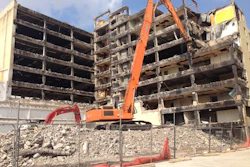Following a highly complex selective demolition of the top three floors, demolition contractor Grant Mackay moved into the next phase utilizing the 750 Hitachi with a 130-ft. reach going up to nine stories.