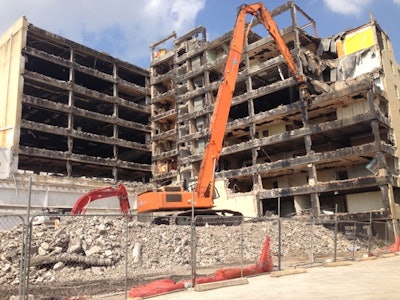 Following a highly complex selective demolition of the top three floors, demolition contractor Grant Mackay moved into the next phase utilizing the 750 Hitachi with a 130-ft. reach going up to nine stories.