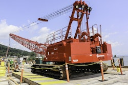 The 110-ton-capacity Manitowoc 11000-1 was erected on a trestle, where it loads and unloads supplies from barges working along the waterway, plus is used as an accessory crane.
