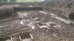 Spring rains left this foundation with standing water in the excavation. Concrete placements should take place promptly before saturation of the grade occurs.