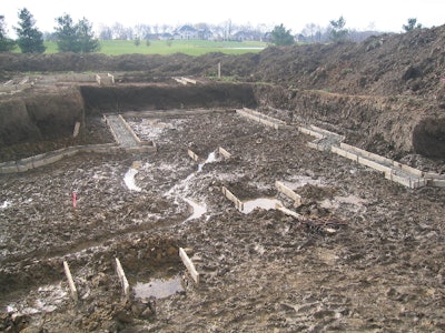 Spring rains left this foundation with standing water in the excavation. Concrete placements should take place promptly before saturation of the grade occurs.