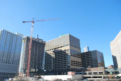 The tower crane is lifting a variety of materials, such as 50-ft. steel columns, table forms, large air handlers, cooling towers, chillers, boilers and steel stairs.