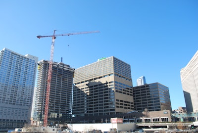 The tower crane is lifting a variety of materials, such as 50-ft. steel columns, table forms, large air handlers, cooling towers, chillers, boilers and steel stairs.