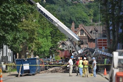 Worker error may be to blame after a crane tips over while lifting scaffolding.
