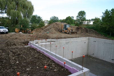 Pictured here is a foundation fully backfilled without a top connection in place. Short walls, corners, offsets and a yard wall provide stability for the backfill before the top connection is in place.