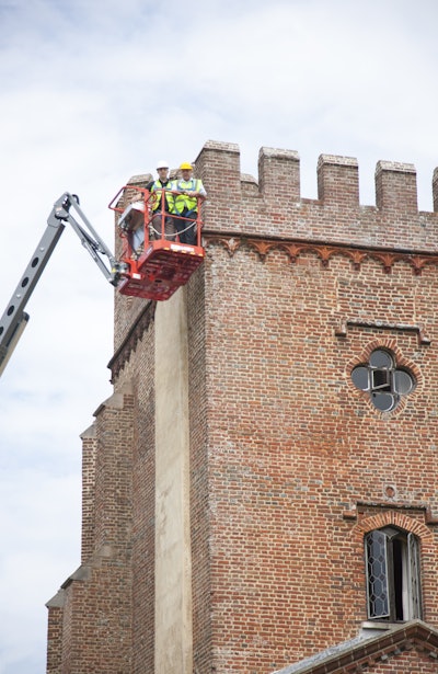 (From left to right) Dean Marks, Skyjack European sales manager, and Ian Brown from Winner Plant assess Laughton Place on the Skyjack SJ63 AJ, which The Landmark Trust used to repoint parts of the historic building.