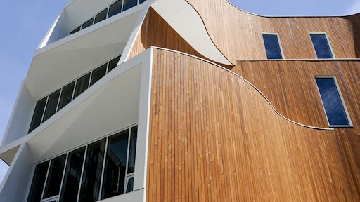 The building features distinct curves and apertures that make it standout visually as well as allow sunlight and shade to be optimized for the lighting and temperature, saving energy and enhancing comfort levels for occupants.