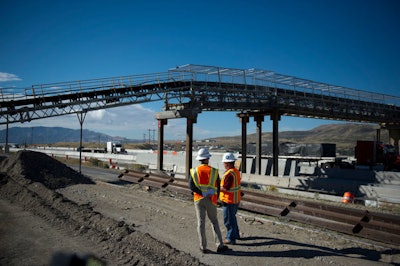 UDOT Point Project director Tim Rose talks with KSL reporter Jed Boal next to a conveyor belt used to transport concrete to the construction zone in Draper on Tuesday, Oct. 6, 2015.