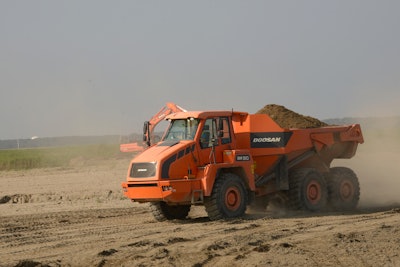 The articulated dump trucks make dozens of trips each day hauling sand. By the time the project is completed, they will have delivered more than 160,000 cu. yds. of it to the breakwaters.