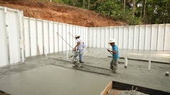 Finishing a basement slab requires vibrating screeds to consolidate and set the final slab elevation before initial set and the remainder of the finishing operation.