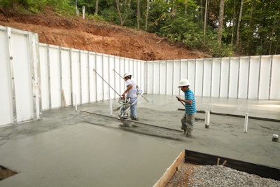 Finishing a basement slab requires vibrating screeds to consolidate and set the final slab elevation before initial set and the remainder of the finishing operation.