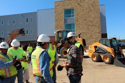 Kip Moore signs autographs for workers at the site of a new high school under construction in San Antonio.