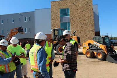 Kip Moore signs autographs for workers at the site of a new high school under construction in San Antonio.