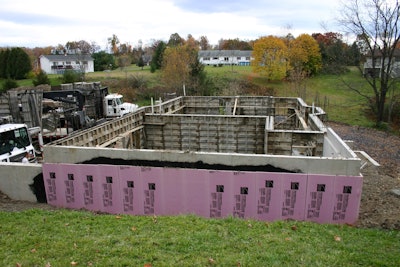 Two-inch (R-10) extruded polystyrene rigid insulation board applied after wall form removal and dampproof coating.