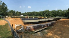 “The paving of tennis courts, sports courts, and running tracks is what we call the plastic surgery of paving,” says Eric Finley, owner of Finley Asphalt. “The smoothness tolerance is typically ¼” when checked with a 10’ straight edge, and of course no standing water. The goal is to have the asphalt surface as flat as possible with just enough slope to drain the water off. Typically most parking lots are designed with 1.5% to 2% slope. Sports surfaces range from .83% to 1%.”