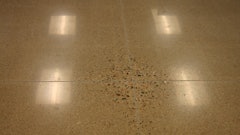 When slabs on ground are polished, non-uniform exposure of aggregate is a result of high spots cause by slab curling. Deflection of many suspended slabs exceeds the upward movement at curled slabs, so polishing may result in even larger areas that exhibit such non-uniform aggregate exposure.