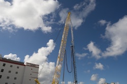 Heavy equipment and workers drill 150 feet deep, sinking first set of piles in phase one of construction for Miami Worldcenter.