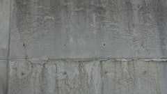 Lines formed by the bubbling and subsequent movement of hydrogen at the interface of new, untreated aluminum forms and concrete prior to initial set are commonly misunderstood as cracks. This wall is more than fifteen years old and exposed throughout its duration with no protective coating. It is a yard wall formed for the sole purpose of pre-treating new aluminum forms, a process they no longer use due to manufacturer pre-treatments.