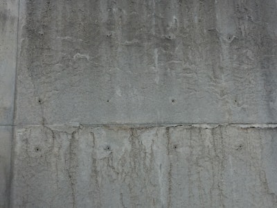 Lines formed by the bubbling and subsequent movement of hydrogen at the interface of new, untreated aluminum forms and concrete prior to initial set are commonly misunderstood as cracks. This wall is more than fifteen years old and exposed throughout its duration with no protective coating. It is a yard wall formed for the sole purpose of pre-treating new aluminum forms, a process they no longer use due to manufacturer pre-treatments.