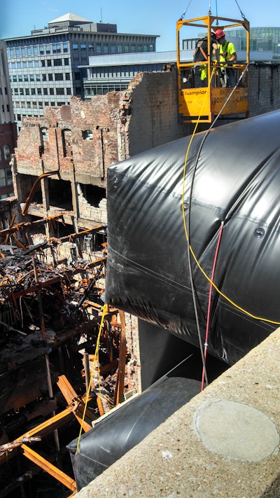 The bags would take up the void air space and put pressure on the wall so it couldn’t kick back toward the adjacent parking structure. If the wall were to collapse, the only way it could fall would be into the hole of the burnt building.