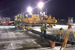 Archer Western Construction LLC's GHP-2800, using a Leica Geosystems 3D guidance system, comes off an evening’s header and paves down ramps off the new 16.5-in.-thick section of runway.
