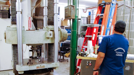 The compression testing machine shown here is used for testing compressive strength and MOE.
