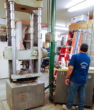 The compression testing machine shown here is used for testing compressive strength and MOE.