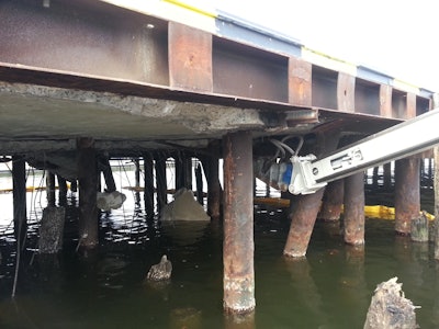 The KT-30 machine broke up the concrete, and the divers moved it away from the new pilings. The barges were then relocated and the process started again.