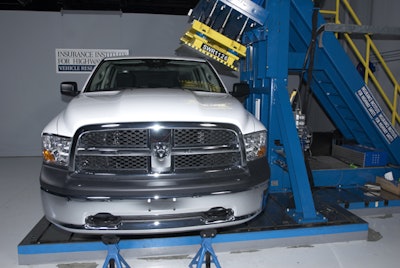The IIHS measures the exact amount of deflection a roof will absorb with a constant and even amount of force from a flat metal plate applied by this monstrous machine. But they don't test heavy-duty pickup trucks.
