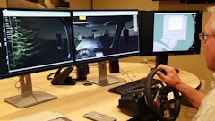 Mike Lucht, 1-800-SWEEPER president and founder, takes a 'test drive' on the organization's new training simulator. Note the trees out the left side view of the cab, the debris field immediately ahead of the sweeper, and the overhead view on the right-hand screen.