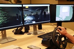 Mike Lucht, 1-800-SWEEPER president and founder, takes a 'test drive' on the organization's new training simulator. Note the trees out the left side view of the cab, the debris field immediately ahead of the sweeper, and the overhead view on the right-hand screen.