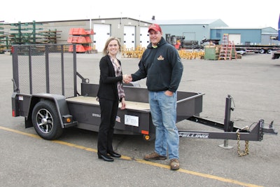 Pictured is the winning bidder of Felling Trailers’ FT-3 drop deck trailer, Patrick Stepan and Brenda Jennissen, Felling Trailers’ President/CEO.