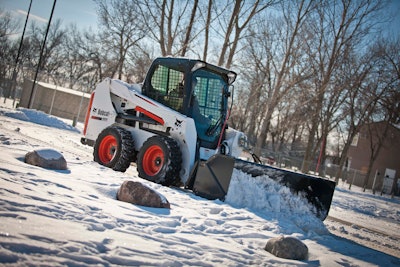 Unlike a pickup truck with a snow blade, a skid-steer loader is not only able to push snow, but lift, pile or load it for transport.
