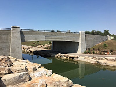Creating a very distinguishing look for the park’s new vehicular bridge, the arched bridge fascia panels, cast with wood grain finish, were installed three on each side of the bridge and the column pier caps were mounted on top of the bridge columns.