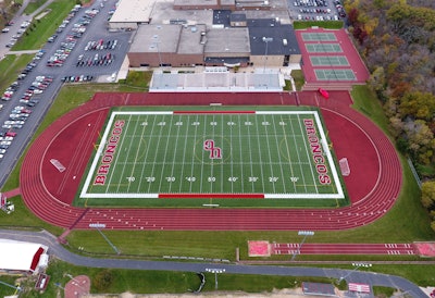 Approximately 1,800 tons of E mix asphalt was placed in two layers. ACI laid the base course, placed tack and then placed the surface course of the running track.